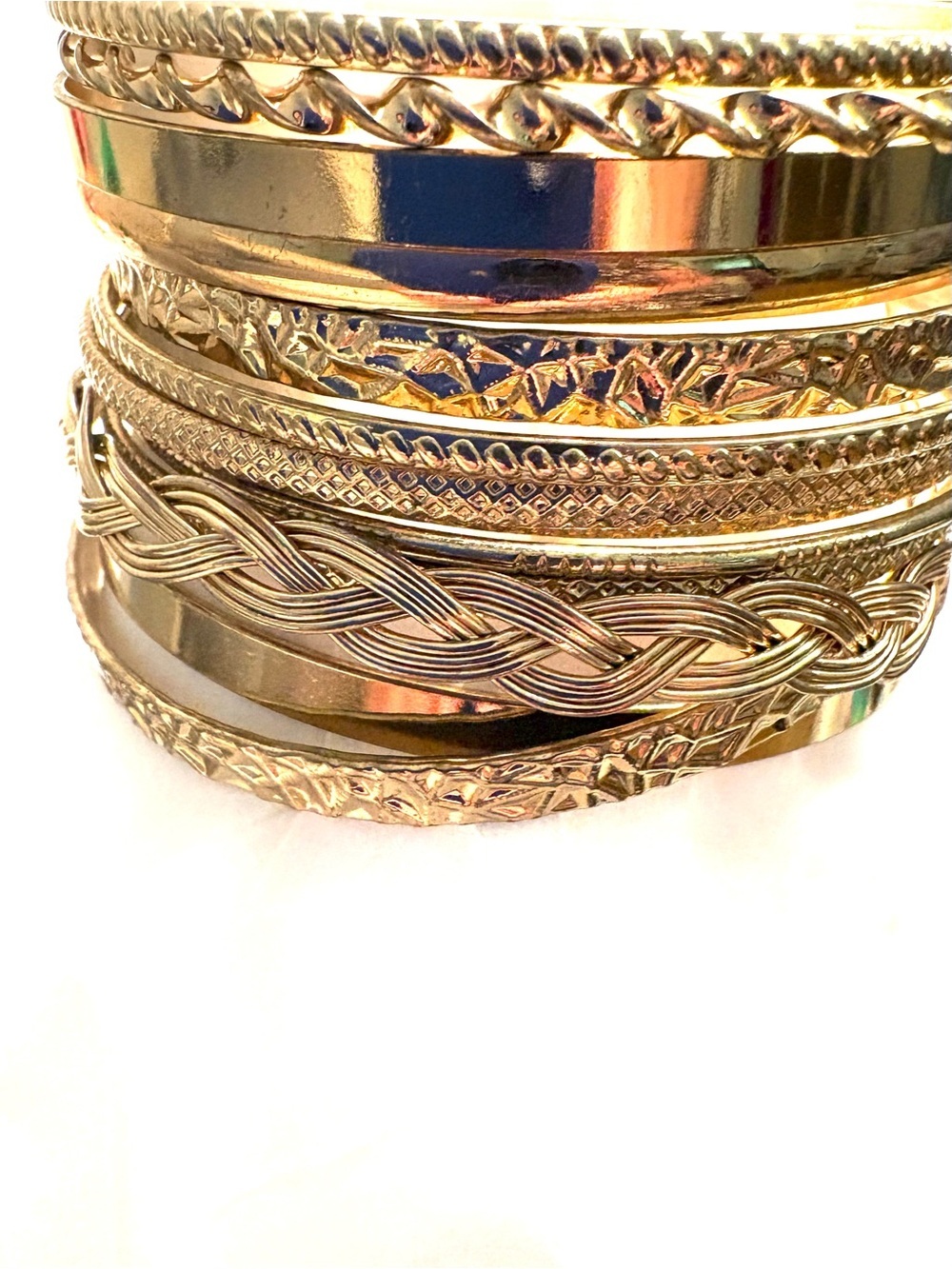 FASHION JEWELRY A Stack of 13 Different
Gold Bangle Bracelets
